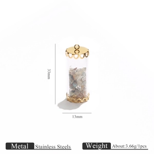 Detail view of 33mm cylindrical glass pendant with natural stones and gold steel caps