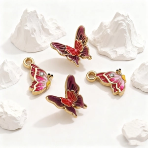 Golden stainless steel butterfly pendants with colorful enamel inlay and crystal accents