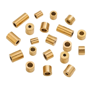 Detailed view of polished gold stainless steel cylinder spacer beads for DIY jewelry