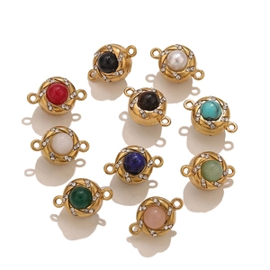 Detail of round gold-plated jewelry connectors with sparkling rhinestones and colorful gems