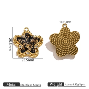 Macro view of gold stainless steel star pendant with black foil and size dimensions