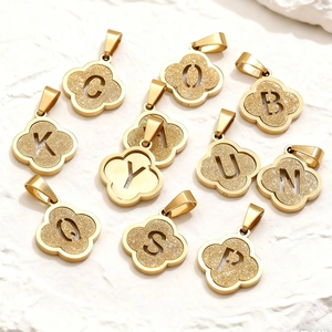 Gold plated stainless steel clover pendants with glitter letters and frosted finish