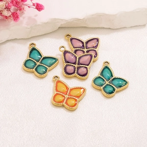 Colorful butterfly pendants in stainless steel with gold plating and enamel inlay