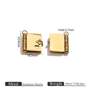 Detail view of gold stainless steel book locket with heart cutout and dimensions