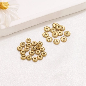 Macro detail of 18K gold-plated twisted rope beads for DIY jewelry making and bead spacers