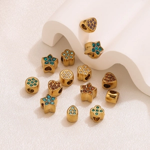Macro detail of 18K gold plated charms with multicolor rhinestones for DIY jewelry making