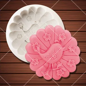 Detail of bird and flower relief on white silicone mold and pink finished resin craft