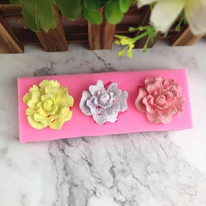 Detailed macro view of 3-hole rose silicone mold with realistic floral textured patterns