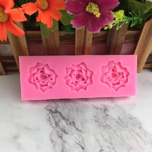 Pink silicone mold featuring three detailed rose cavities for DIY fondant and soap making
