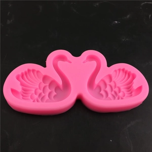 Detailed macro view of a pink swan-shaped silicone mold with fine feather texture