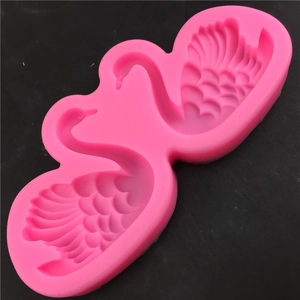 Pink silicone mold featuring dual swan designs for fondant and chocolate DIY crafts
