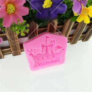 Detailed close-up showing the intricate ark and castle shapes inside pink silicone mold