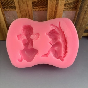 Detailed close-up of a pink flexible silicone mold with two DIY little angel character shapes