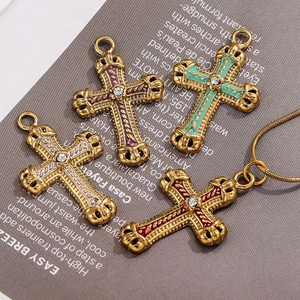 Detailed view of vintage enamel cross pendants in gold finish with vibrant colorful inlay