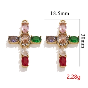 Detailed view of 18K gold plated stainless steel cross pendants with multi-color gemstones