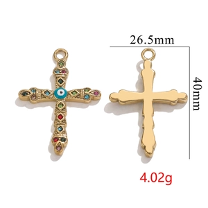 Detail view of 18K gold plated cross pendant with evil eye and colorful stones