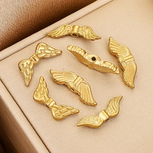 Set of six gold plated wing beads for DIY jewelry making with polished metal texture