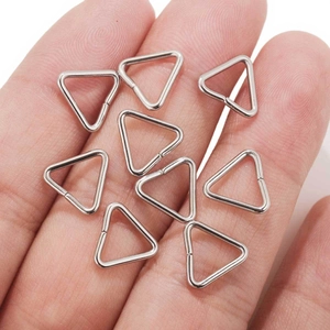 Set of DIY stainless steel triangle d-rings for bags held in hand to show the small scale