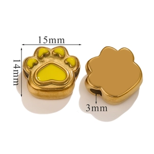 Macro view of 15mm golden stainless steel paw print beads with yellow enamel for DIY