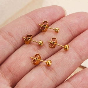 4-piece gold stainless steel stud earring set with ball and cylinder designs on palm