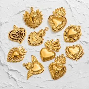 Detail of vintage 18K gold plated stainless steel sacred heart pendants on stone