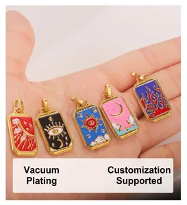 Detail of tarot pendants with colorful enamel sun and moon designs in gold frames