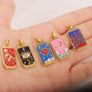Five gold-plated stainless steel tarot charms with colorful enamel in palm display