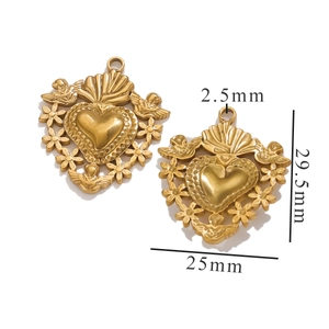 Macro detail of 25x29.5mm gold sun heart pendant with vintage floral embossed pattern