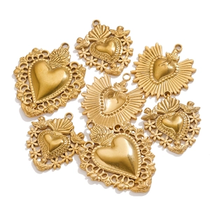 Detailed macro view of 18K gold plated sacred heart pendants with vintage sunburst motifs