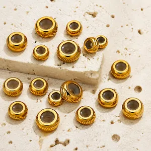 Macro detail of golden stainless steel beads with sunburst and faceted textures