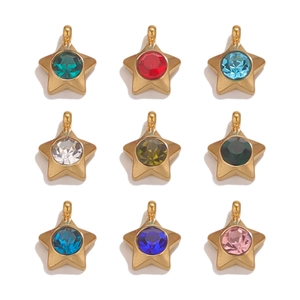 Macro detail of 18K gold plated star pendants with colorful inset crystals for DIY jewelry