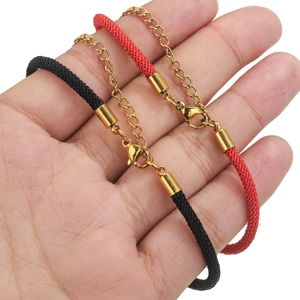 Detail of adjustable red and black woven bracelets with golden lobster clasps and chains