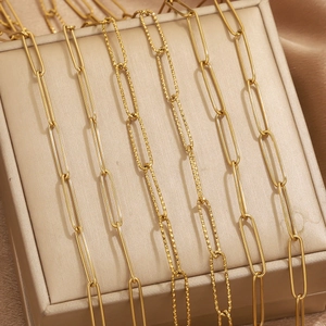 Detail of PVD gold plated stainless steel paperclip chains with smooth and hammered textures