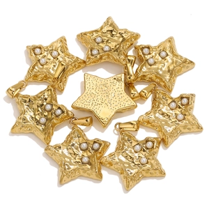 Macro detail of eight gold star pendants with hammered texture and white pearls