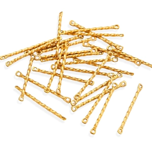 Detailed macro view of golden twisted metal links with double loops for DIY jewelry making