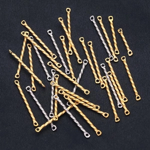 Detailed view of spiral twisted metal connector bars for DIY jewelry making in gold and silver