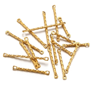 Macro view of gold twisted metal connectors for DIY jewelry making accessories