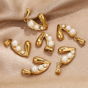 Golden heart-shaped charms with three white pearls on elegant champagne silk background