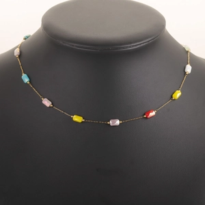 Detailed view of 18k gold plated necklace with colorful faceted beads on black mannequin
