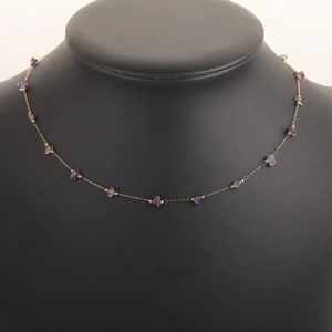 Detail of 18k gold plated necklace with small purple natural amethyst stone beads