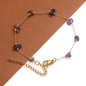 Detail of 18k gold plated bracelet with purple amethyst stones and lobster clasp closure