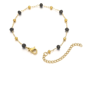 Detail of 18k gold plated chain bracelet featuring black faceted beads and lobster clasp