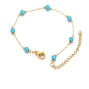 Close-up of gold stainless steel bracelet with blue turquoise beads and lobster clasp