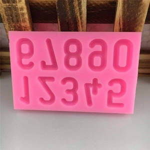 Pink silicone number mold with digits 0-9 and plus sign for DIY chocolate or fondant cakes