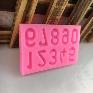 Pink silicone DIY number and letter mold for fondant cake or chocolate craft on wooden base