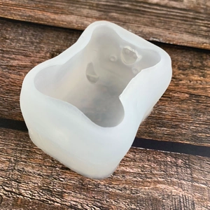 Translucent silicone piglet cake mold for DIY baking and mousse crafts on wood background