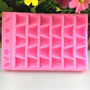 Pink silicone alphabet mold for DIY fondant cakes with flower and leaf shapes