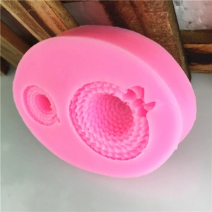 Pink silicone mold featuring two sizes of miniature straw hat shapes for cake decorating