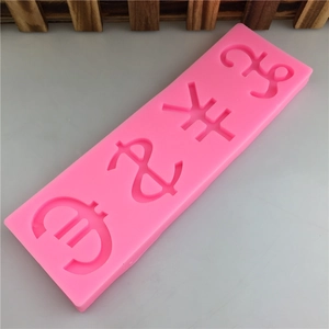 Pink silicone mold featuring dollar, euro, pound, and yen currency symbols for cake fondant