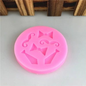 Pink silicone mold featuring mustache, bowtie and necktie shapes for DIY fondant cakes
